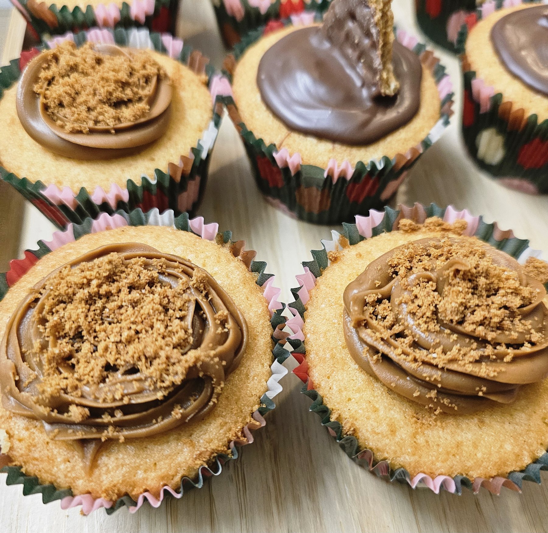 Chocolate topped cupcakes with biscuit pieces