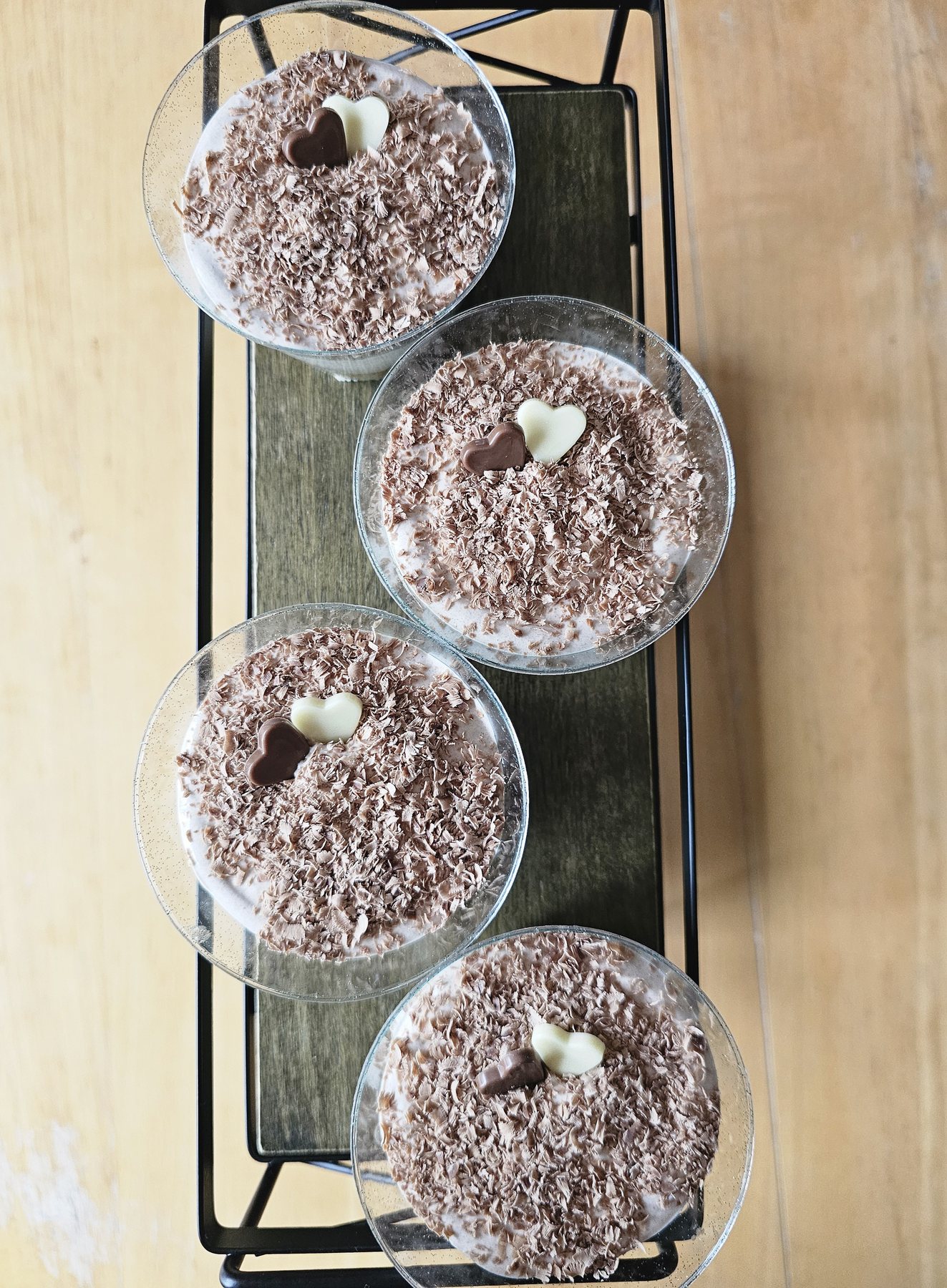 Individual dessert cups topped with chocolate shavings