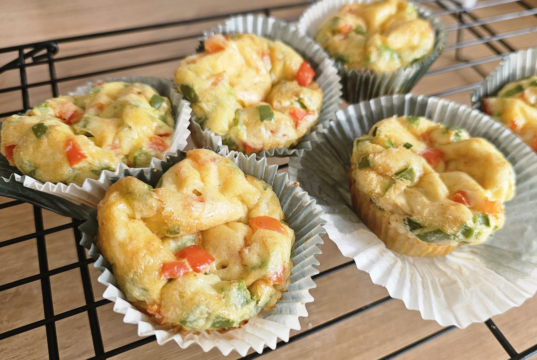 Mini savoury egg muffins cooling on a rack