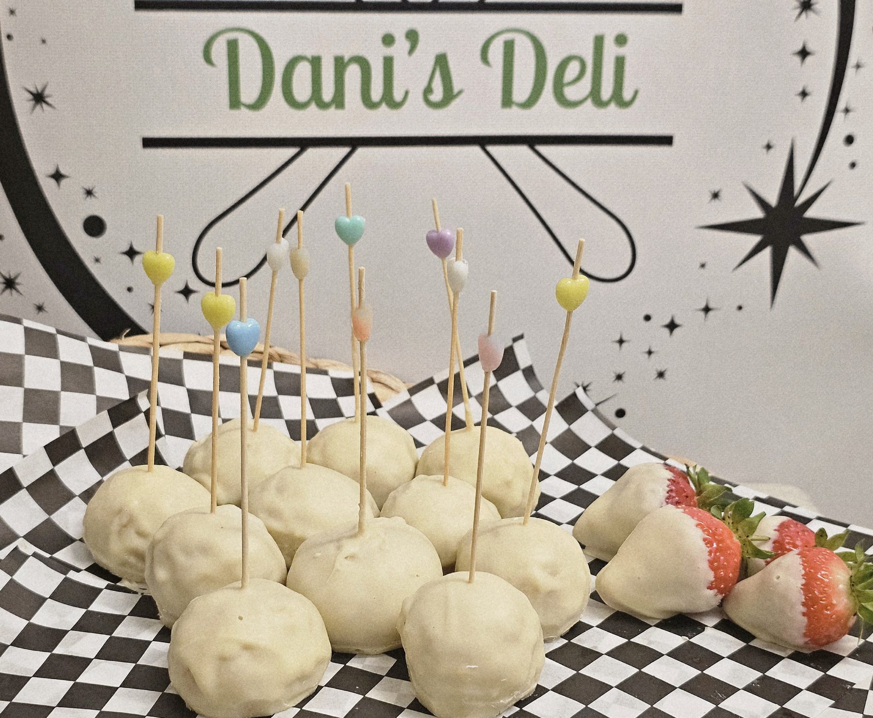 White chocolate cake pops and dipped strawberries